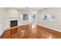 Open-concept living room with hardwood floors and a cozy fireplace at 5063 Eldora Ave # 4, Las Vegas, NV 89146