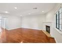 Spacious living room featuring gleaming hardwood floors and a classic fireplace at 5063 Eldora Ave # 4, Las Vegas, NV 89146