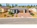 Attractive single-story home with a three-car garage, appealing landscaping and paved driveway at 5357 Eleganza Ave, Pahrump, NV 89061