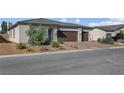 Close-up of a single-story home with a three-car garage and attractive rock landscaping at 5357 Eleganza Ave, Pahrump, NV 89061