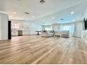 Expansive living room featuring wood floors, recessed lighting, a large sofa, and an open concept at 6191 Bullion Blvd, Las Vegas, NV 89103