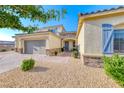 Two-story stucco home with stone accents and a two-car garage at 6311 Baker Creek St, Las Vegas, NV 89149