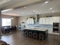 Open concept kitchen showcases a large island with seating, stainless appliances, and modern finishes at 6311 Baker Creek St, Las Vegas, NV 89149