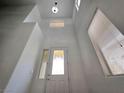 Bright and airy foyer with high ceilings and contemporary lighting, showcasing the home's modern design at 6638 Babys Tear Pl, Las Vegas, NV 89148