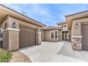 Beautiful home showcasing meticulous landscaping and an inviting driveway leading to a two-car garage at 7332 Redhead Dr, North Las Vegas, NV 89084