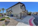 Attractive townhome exterior featuring low-maintenance landscaping at 7505 Emerald Stars St # 101, North Las Vegas, NV 89084