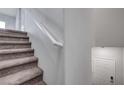 Carpeted staircase with a white handrail at 7505 Emerald Stars St # 101, North Las Vegas, NV 89084