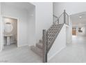 Bright entryway with tile flooring, staircase with metal railing, and a convenient powder room at 789 Black Palace St, Henderson, NV 89011