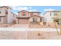 Inviting two-story home showcasing a two-car garage, desert landscaping, and a paved driveway at 789 Black Palace St, Henderson, NV 89011
