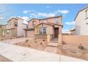 Charming two-story home with a covered front entry, desert landscaping, and brick accents on the exterior at 789 Black Palace St, Henderson, NV 89011