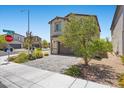 Charming two-story home featuring a brick driveway, desert landscaping, and neutral color palette at 8261 Selenite St, Las Vegas, NV 89113