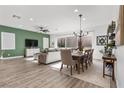 Open-concept living room and dining area with stylish furnishings, hardwood floors, and abundant natural light at 8705 Fordster St, Las Vegas, NV 89166