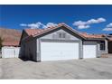 Spacious three-car garage featuring white doors and concrete driveway at 878 Samoy St, Las Vegas, NV 89110
