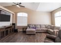 Comfortable living room features a sectional sofa, a large window, and hardwood floors at 878 Samoy St, Las Vegas, NV 89110