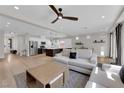 Spacious living area features wood flooring, neutral colors, modern furnishings, and seamless kitchen access at 9604 Stoney Mesa Ct, Las Vegas, NV 89139