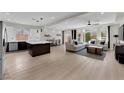 Bright, open-concept living space with wood floors, modern furnishings, and an eat-in kitchen at 9604 Stoney Mesa Ct, Las Vegas, NV 89139