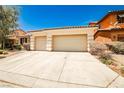 Charming single story home featuring a tile roof, a two car garage, and desert landscaping at 9987 Shiloh Heights St, Las Vegas, NV 89178