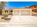 Charming single story home featuring a tile roof, a two car garage, and desert landscaping at 9987 Shiloh Heights St, Las Vegas, NV 89178