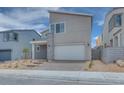 Modern home featuring a two-car garage and low maintenance desert landscaping at 10465 Smokey Mariposa, Las Vegas, NV 89166