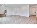 Bright and spacious living room with light wood floors and staircase access at 10465 Smokey Mariposa, Las Vegas, NV 89166