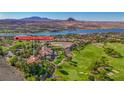 Stunning aerial view of a home near a golf course, lake, and mountains, showcasing luxury living at 12 Strada Di Circolo, Henderson, NV 89011