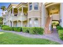 Beautiful building exterior featuring balconies, stairs and green grass at 12 Strada Di Circolo, Henderson, NV 89011