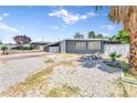 Single story home with desert rock landscaping in the front yard and tall palm tree at 1713 E Bonanza Rd, Las Vegas, NV 89101