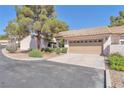 Charming single-story home with a low-pitched tile roof, desert landscaping, and a two-car garage at 1951 Moyer Dr, Henderson, NV 89074