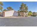 Side view of desert home featuring a low-pitched tile roof, desert landscaping, and stucco exterior at 1951 Moyer Dr, Henderson, NV 89074