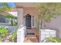 Inviting front entrance with a secure iron gate, tiled entryway, and well-maintained desert landscaping at 1951 Moyer Dr, Henderson, NV 89074