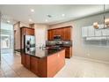 Modern kitchen with stainless steel appliances, dark countertops, and center island with seating at 208 Coltrane Canyon Ave, Henderson, NV 89011