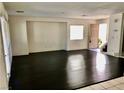 Open living room features dark floors, white walls, and large windows at 224 Wicked Wedge Way, Las Vegas, NV 89148