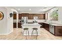 Beautiful kitchen featuring granite countertops, stainless steel appliances, and a center island with seating at 2333 Mundare Dr, Henderson, NV 89002