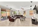 Spacious living room with tile flooring, recessed lighting, and sliding glass doors to the backyard at 2333 Mundare Dr, Henderson, NV 89002