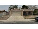 Single story house with a two car garage and a gated courtyard in need of some TLC at 2450 Oak Glen Way, Las Vegas, NV 89115