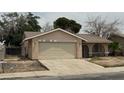 Single story house with a two car garage and a gated front courtyard at 2450 Oak Glen Way, Las Vegas, NV 89115
