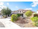 Inviting two-story home with a manicured front yard and a convenient two-car garage at 2608 Campobello Ave, North Las Vegas, NV 89081