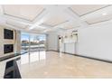 Living area with fireplace, wet bar, tile floors, and floor to ceiling windows with city views at 2777 Paradise Rd # 303, Las Vegas, NV 89109