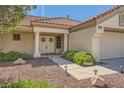 Welcoming front entrance adorned with decorative wreaths, flanked by green shrubs and walkway lighting at 3104 Hayden Ct, Las Vegas, NV 89134