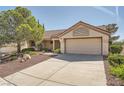 Inviting single-story house with a landscaped yard and attached two-car garage at 3104 Hayden Ct, Las Vegas, NV 89134