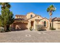 Two-story home featuring a two car garage, well-maintained landscaping and tile roof at 33 Via Di Mello, Henderson, NV 89011