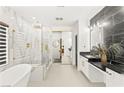 Spa-like bathroom with a freestanding tub, glass-enclosed shower, and double vanity with marble countertops at 366 Rancho La Costa St, Las Vegas, NV 89138