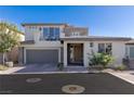 Modern two-story home with a neutral color scheme, stone accents, a two-car garage and a balcony at 4290 Solace St, Las Vegas, NV 89135