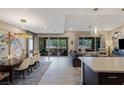 Open-concept living space featuring tile flooring, modern lighting, and access to an outdoor patio at 4290 Solace St, Las Vegas, NV 89135