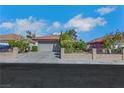 Charming single-story home featuring a tile roof, desert landscaping, and a quaint brick fence at 4629 Denwood Dr, Las Vegas, NV 89147