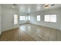 Bright living room featuring tile flooring and multiple windows at 4713 Vista Del Rey Ct, North Las Vegas, NV 89031