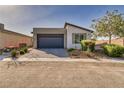 Well maintained single story home with desert landscaping, driveway, and an attached two car garage at 5091 E Beacon Ridge Dr, Pahrump, NV 89061