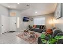 Inviting living room with vaulted ceiling, stylish gray sofas, a decorative rug and modern decor at 517 Casa Del Norte Dr, North Las Vegas, NV 89031