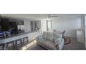 Wide open living area with modern furnishings, open to the kitchen, and plenty of natural light at 5209 Silica Chalk Ave, Las Vegas, NV 89115