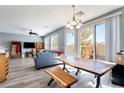 Open-concept living and dining area with wood floors and sliding glass doors, access to backyard at 6121 Mission Gorge Ct, Las Vegas, NV 89130